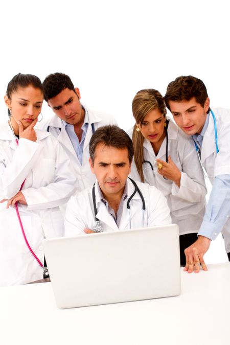 Group of doctors with a computer - isolated over white