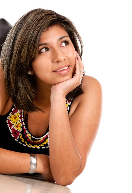 Thoughtful woman lying on the floor ? isolated over white