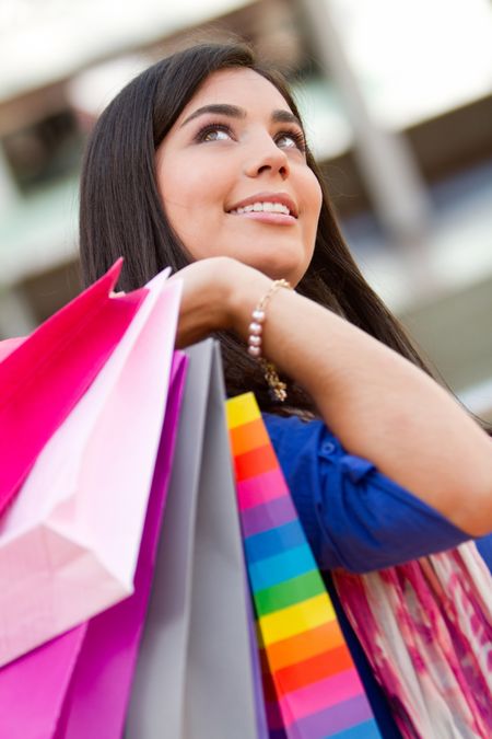 Beautiful shopping woman holding bags at a mall