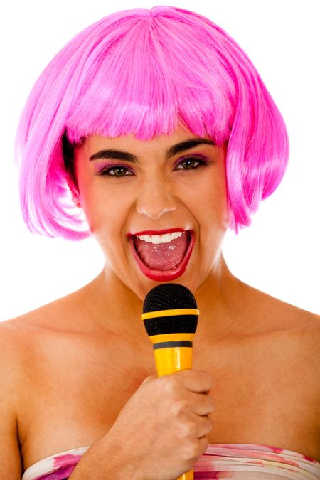 Eccentric woman singing with microphone and pink wig - isolated over white