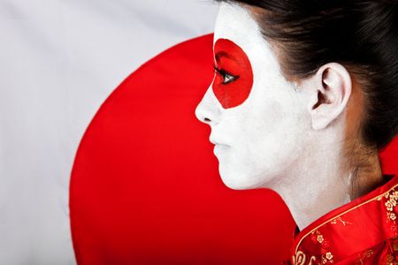 Japanese woman in Asian outfit with the flag behind