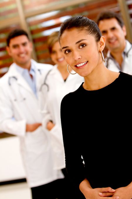 Patient at the hospital with doctors on the background