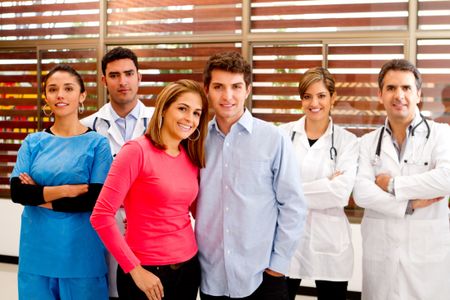 Healthy patients at the hospital with doctors on the background