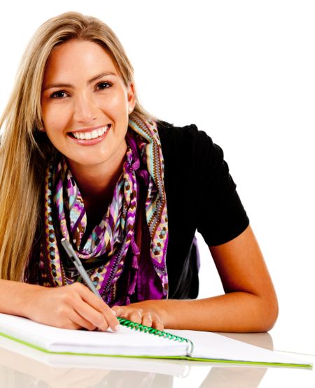 Beautiful female student with a notebook lying on the floor - isolated