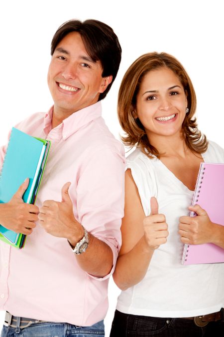 Couple of students with notebooks and thumbs up - isolated