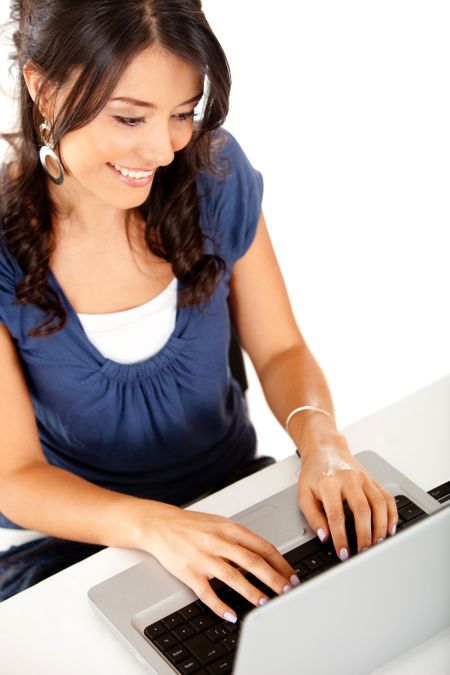 Happy woman working on a laptop computer ? isolated over white