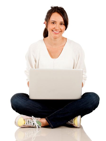 Woman sitting on the floor with a laptop computer - isolated