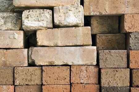 Bricks stacked against a wall