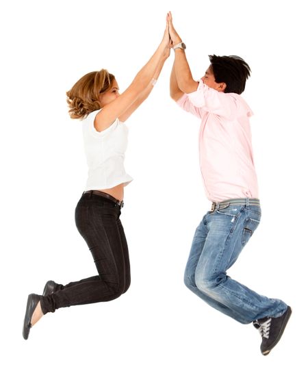 Enthusiastic couple jumping and making a high-five isolated