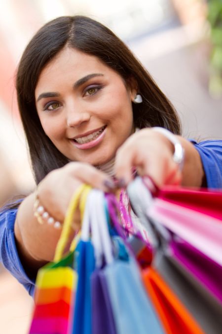 Beautiful shopping woman holding bags at a mall