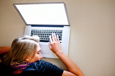 Tired woman sleeping over a laptop computer while working