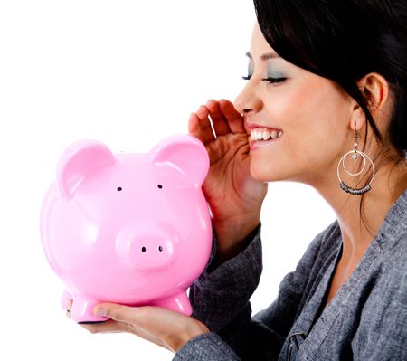 Woman telling a financial secret to a piggybank - isolated