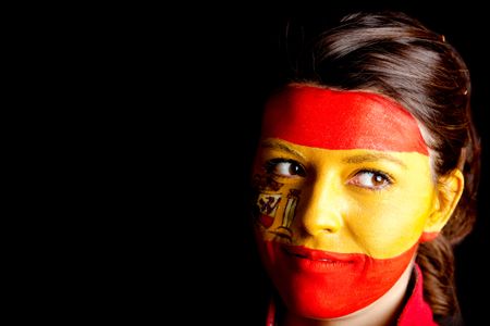 Spanish woman with the flag painted on her face ? isolated over a black background
