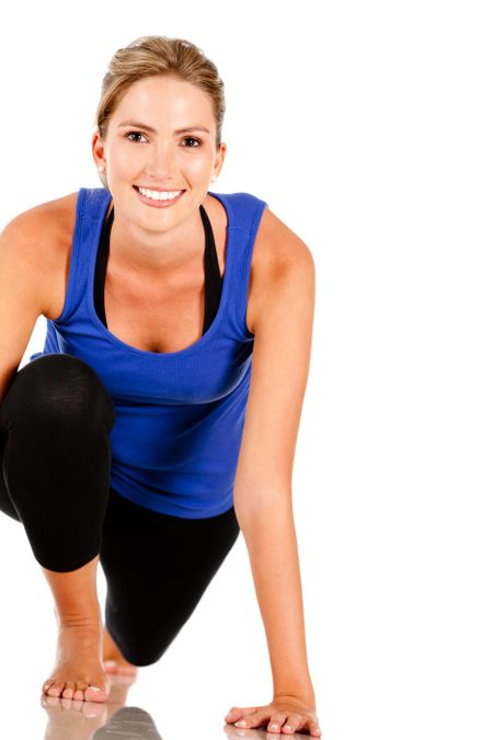 Athletic woman stretching - isolated over a white background