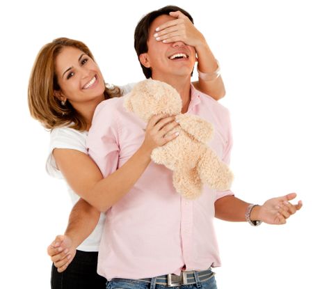 Romantic woman surprising her couple with a teddy bear ? isolated