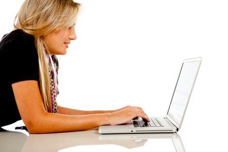 Happy woman working on a laptop computer ? isolated over white