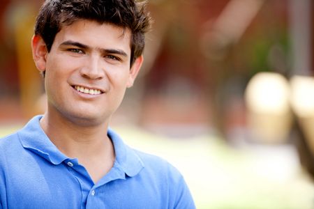 Portrait of a casual man smiling outdoors