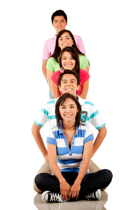 Group of happy friends sitting on the floor making a pyramid ? isolated