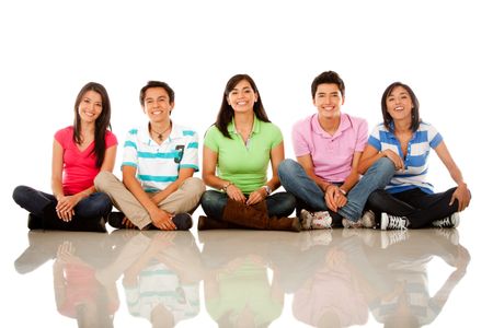 Group of happy friends sitting on the floor ? isolated