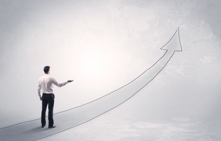 Adult elegant male with briefcase standing on drawn grey arrow pointing up financial concept