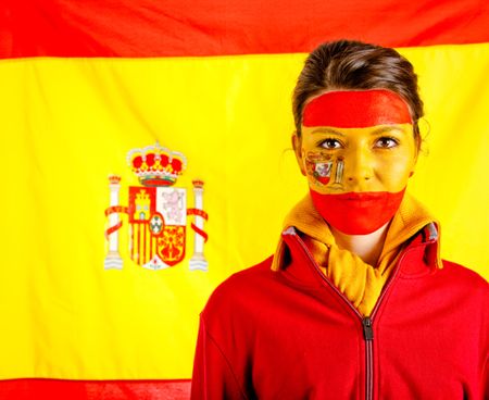 Spanish woman with the flag behind her and paint on her face
