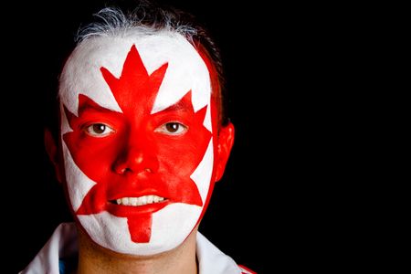 Canadian man with the flag painted on his face ? isolated over black