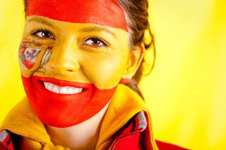 Spanish woman with the flag behind her and paint on her face