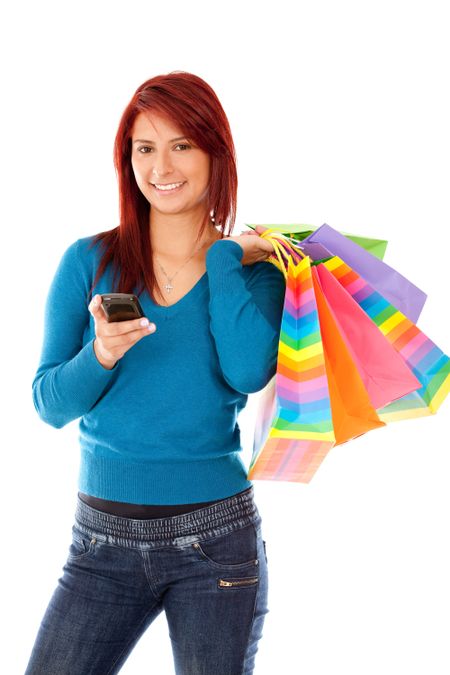 Beautiful shopping woman texting on her cell phone
