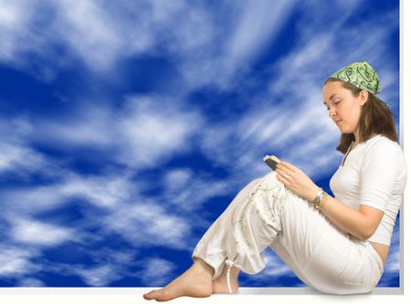 girl reading a book over a blue sky