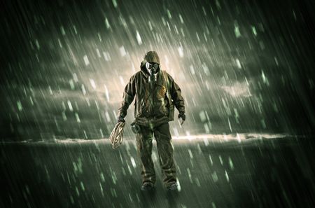 Terrorist in a stormy space with gas mask on his hand and weapons on his arm