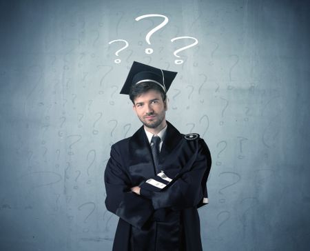 Young graduate teenager with question marks drawn over his head