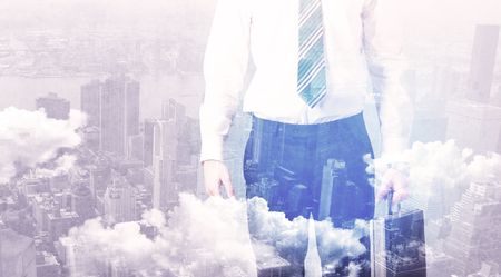 Business man standing at city overlay view background