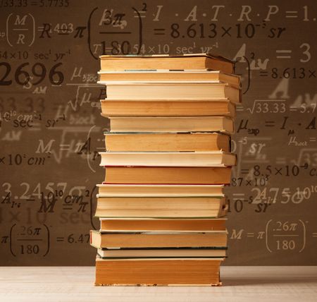 Books on vintage background with math formulas flying out