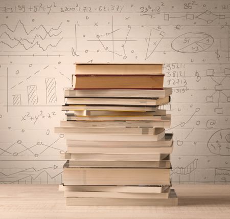 A pile of books with math formulas written in doodle style on background