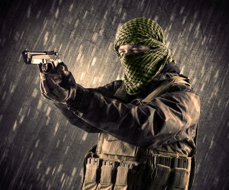 Close up of an armed terrorist man with mask on rainy background