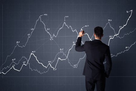 Young businessman in black suit standing in front of a progress chart