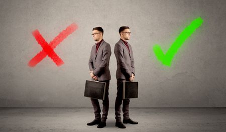 Young conflicted businessman choosing between a right and a wrong direction