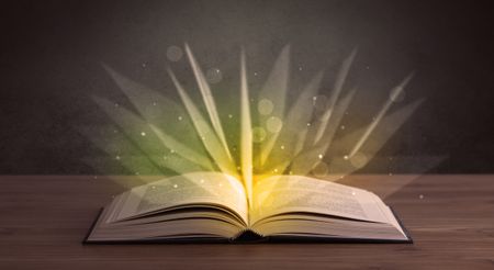 Yellow lights spreading from an open book