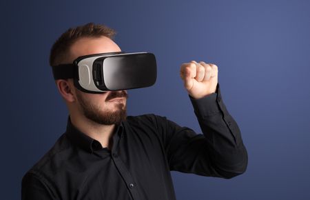 Amazed businessman with virtual reality goggles 