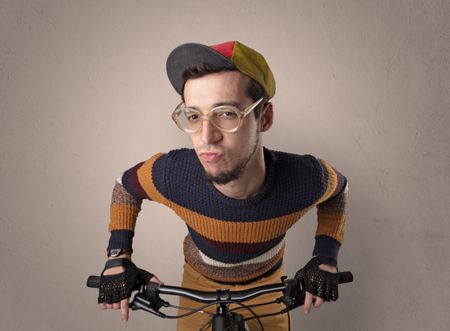 Nerd young foolish biker on a bike with oldschool outfit