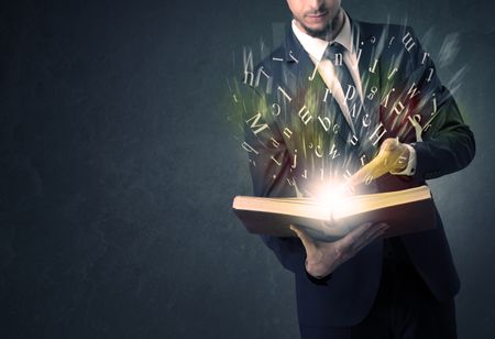 Businessman holding book with letter concept.