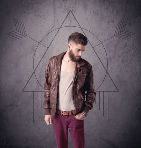A young hipster male in modern clothes standing in front of an urban wall with modern sign illustration concept