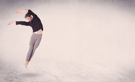 Modern ballet dancer performing art jump with empty copy space background