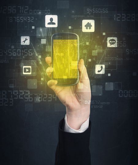 Caucasian hand in business suit holding a smartphone with golden-yellow holographic screen