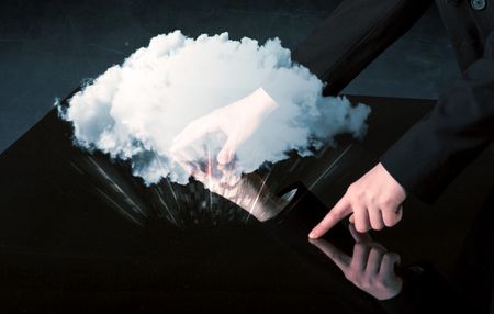 Male hands touching interactive table with a white cloud on it