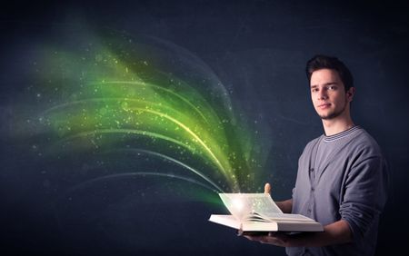 Casual young man holding book with green wave flying out of it