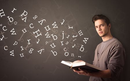 Casual young man holding book with white alphabet flying out of it