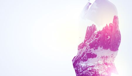  Young businessman in suit standing with sunny snowy mountain and trees graphic.