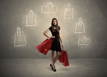 A beautiful young girl in black standing with red shopping bags in front of brown background wall and drawing illustration concept
