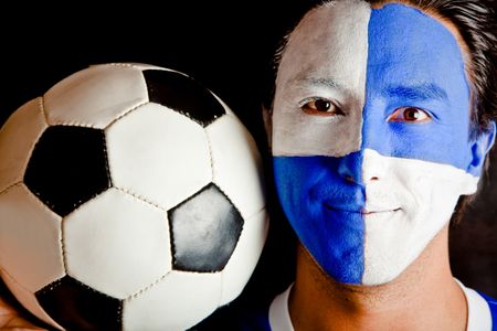 Football fan with a blue and white flag painted on his face